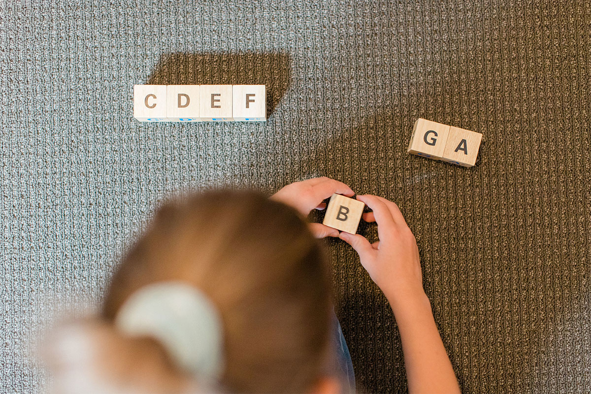 young girl with letters